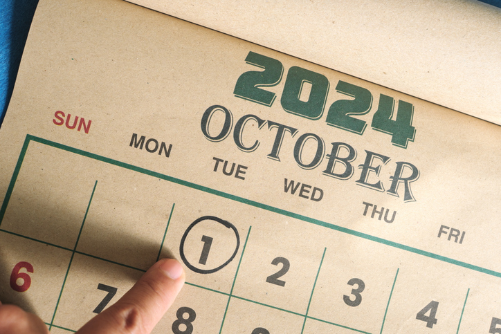 Hand pointing to a calendar with 1 October 2024 circled